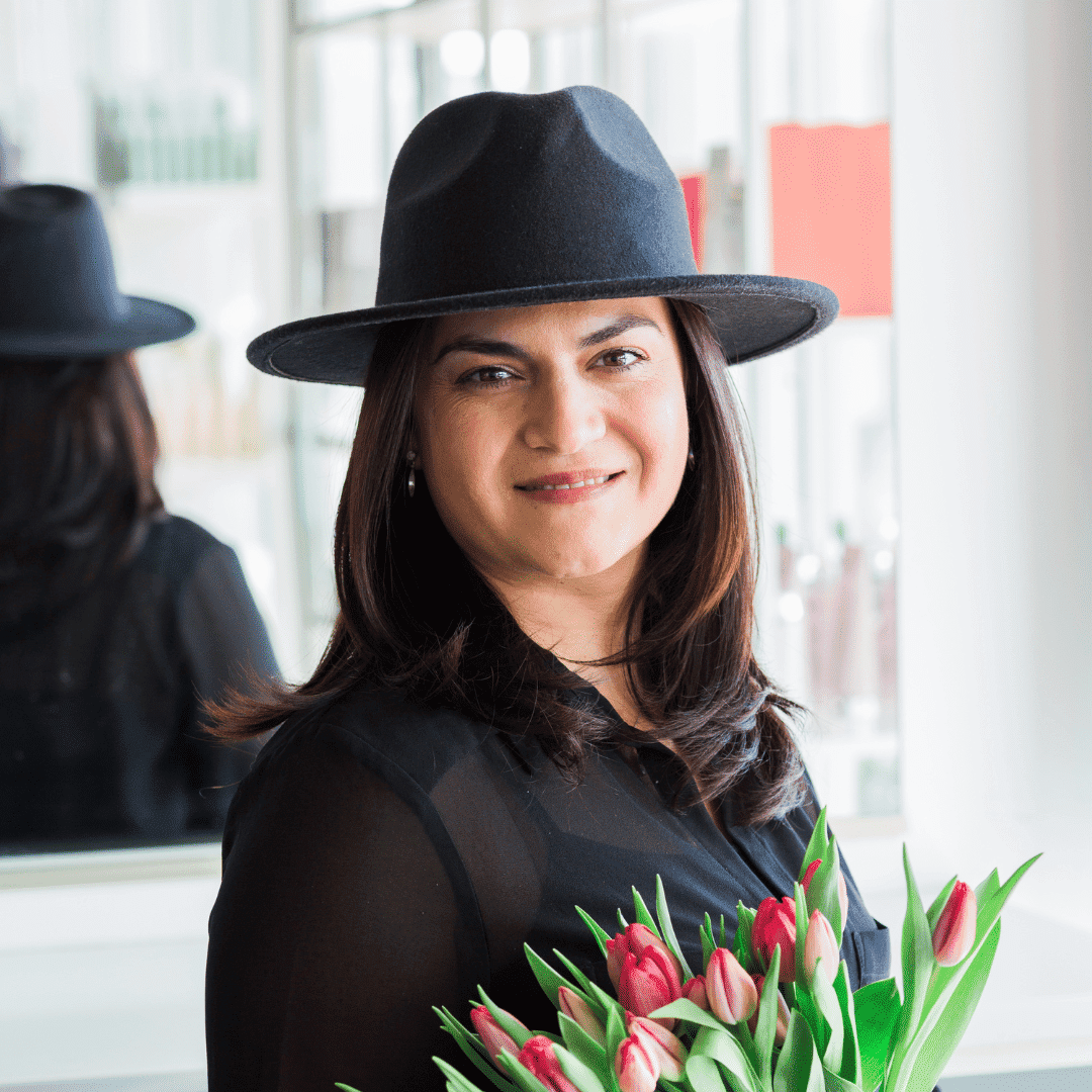 Portrait of Erla, a professional stylist at Escape Blowdry Bar and Salon, showcasing their expertise and style.